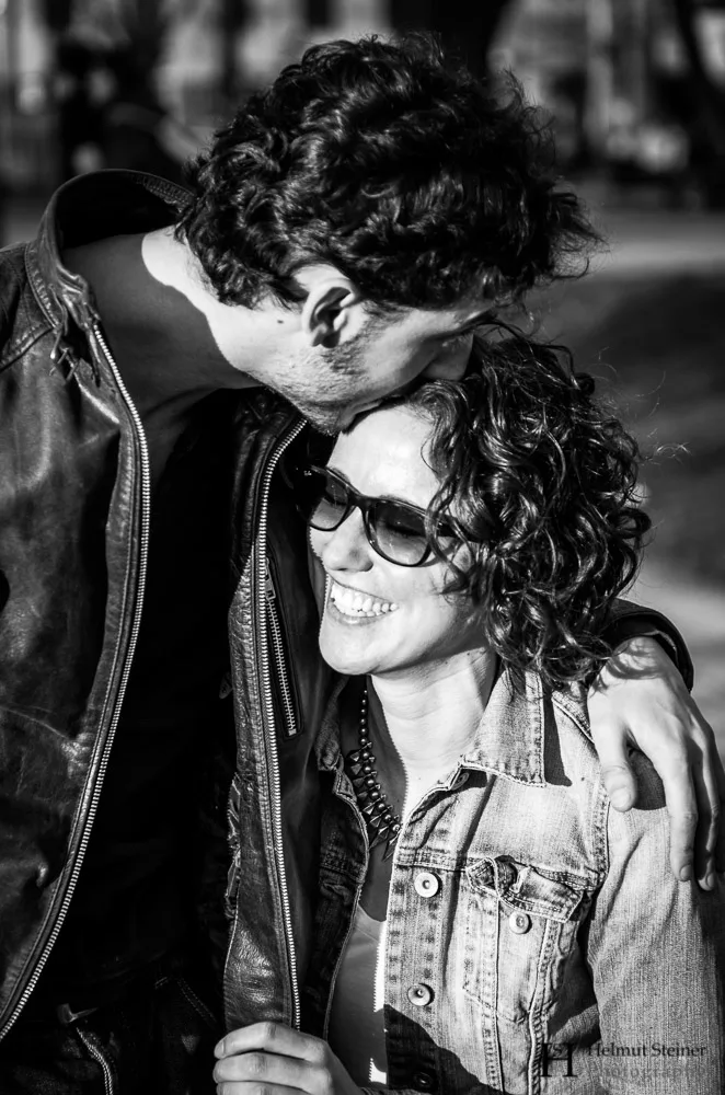 Young girl being kissed on the forehead by her boyfriend