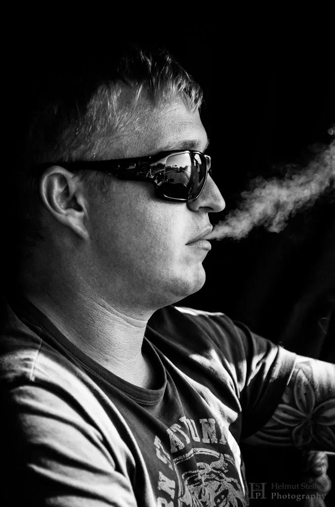 Portrait of a truck driver smoking during driving
