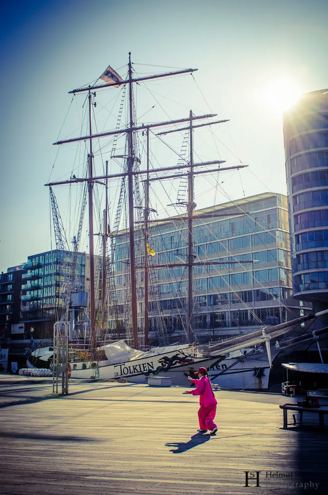 Asian Woman practicing Tai Chi in front of an old sailing ship