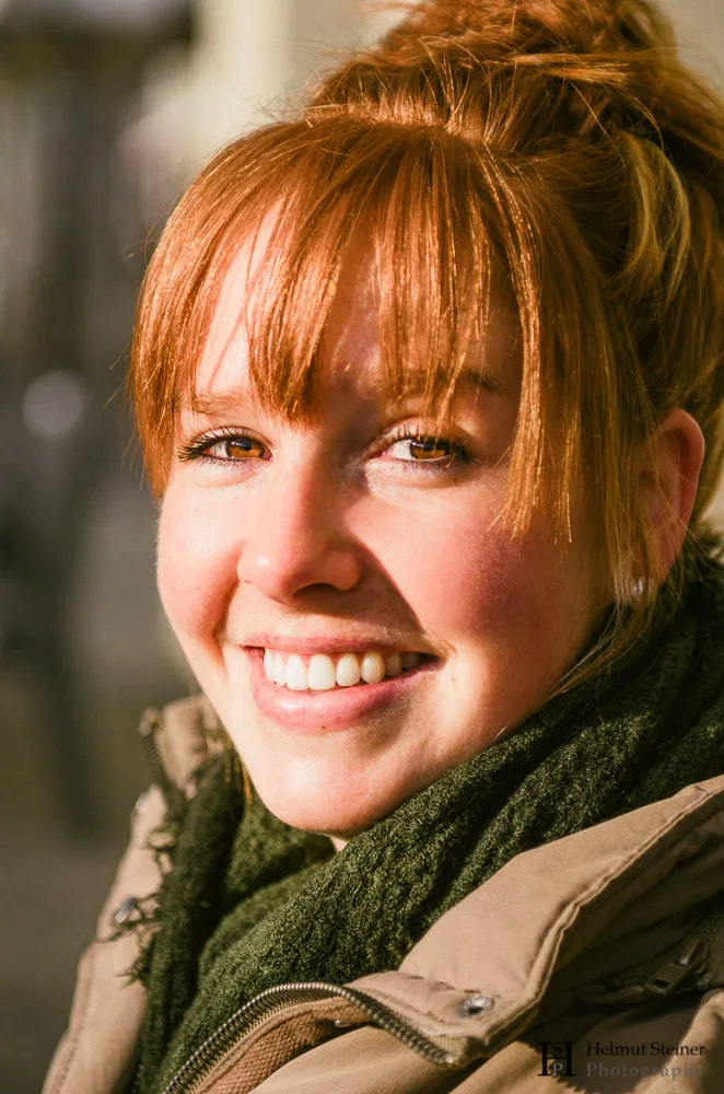 Portrait of a young smiling redhead with a green scarf