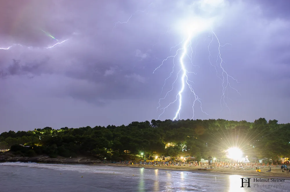 Lightning hitting the forrest close to the sea, Italy