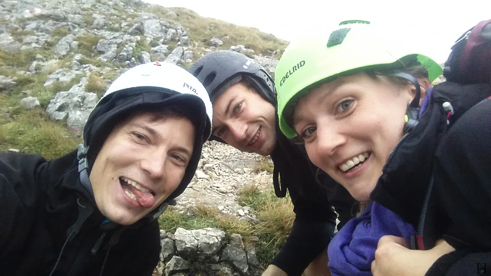 three young people with helmets laughing