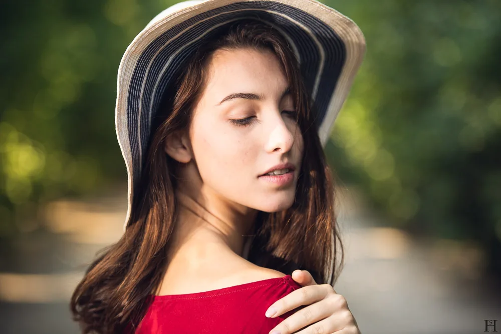 pretty young girl with hat in a park
